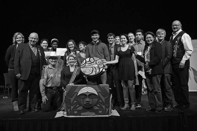 Aboriginal and non-Aboriginal representatives from 4Rs Youth Movement present the 4Rs drum made by Nisga’a artist Mike Dangeli, as an expression of reconciliation at the Truth and Reconciliation Commission Alberta National Event, March 2014.